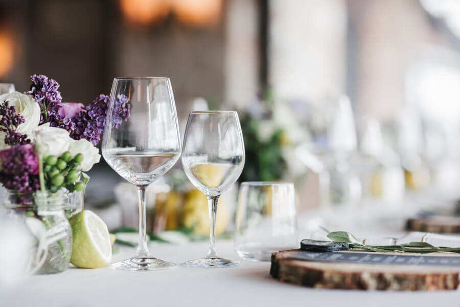 A table setup with flowers and wine glasses